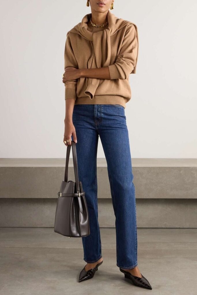 woman in straight-cut blue jeans with bag