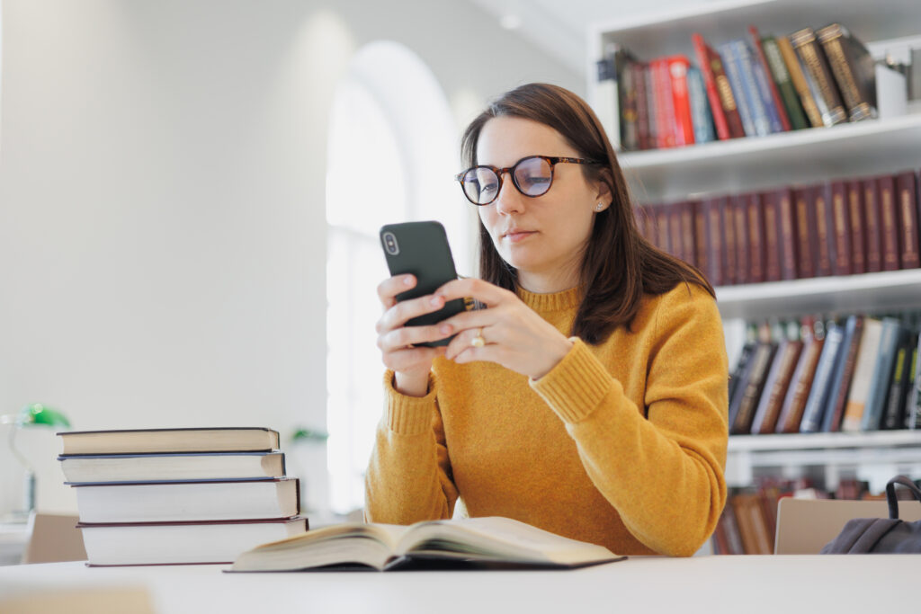 confident woman works in library, in coworking at